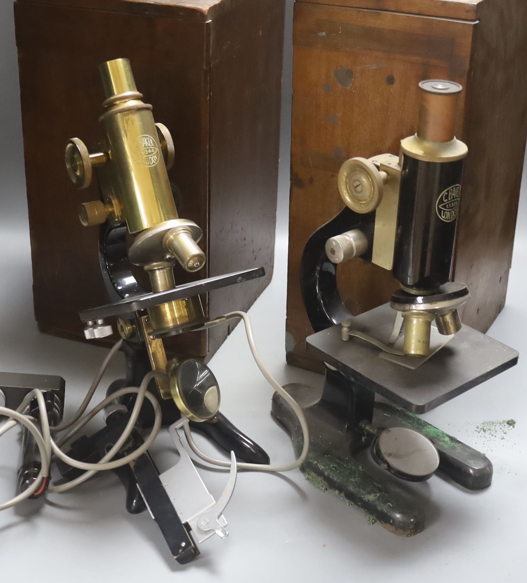 Two mahogany cased microscopes by C. Baker, London, with lenses